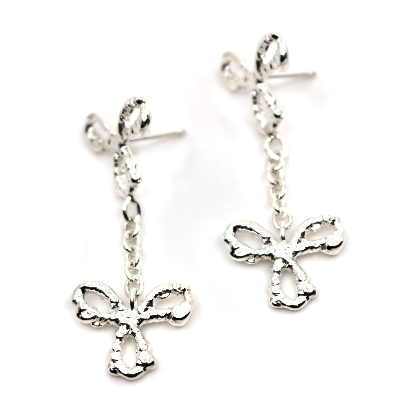 Pair of silver 3 petal flower earrings on a white background