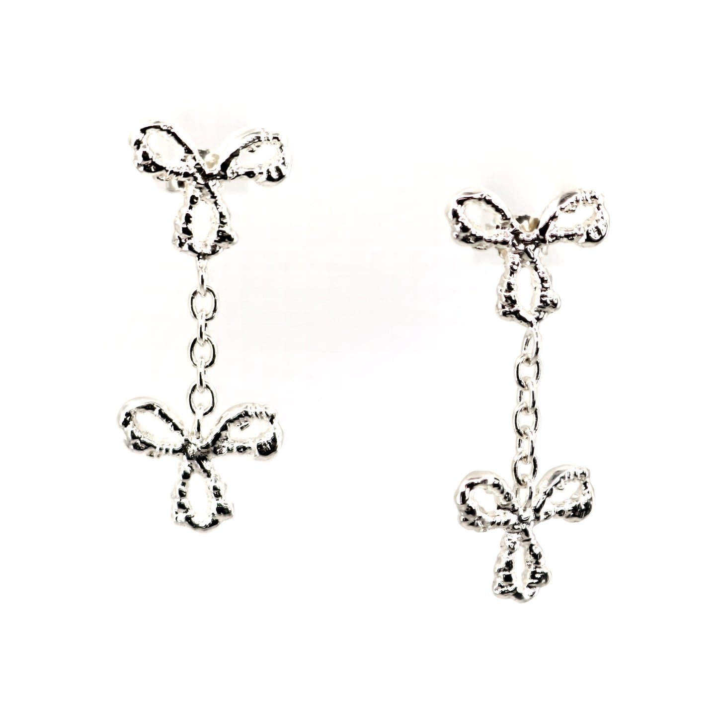 Silver bow-shaped earrings on a white background