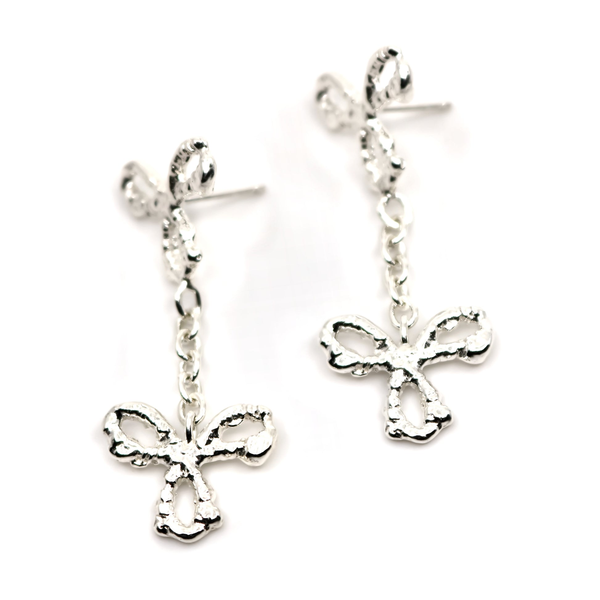 Pair of silver 3 petal flower earrings on a white background