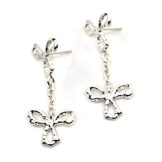 Pair of silver 3 petal flower earrings on a white background