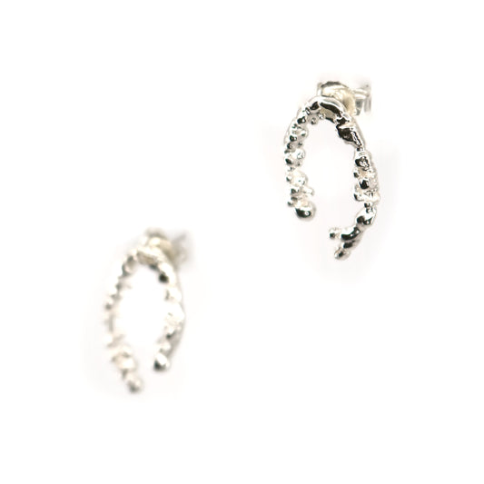 Pair of horseshoe shaped silver earrings on a white background