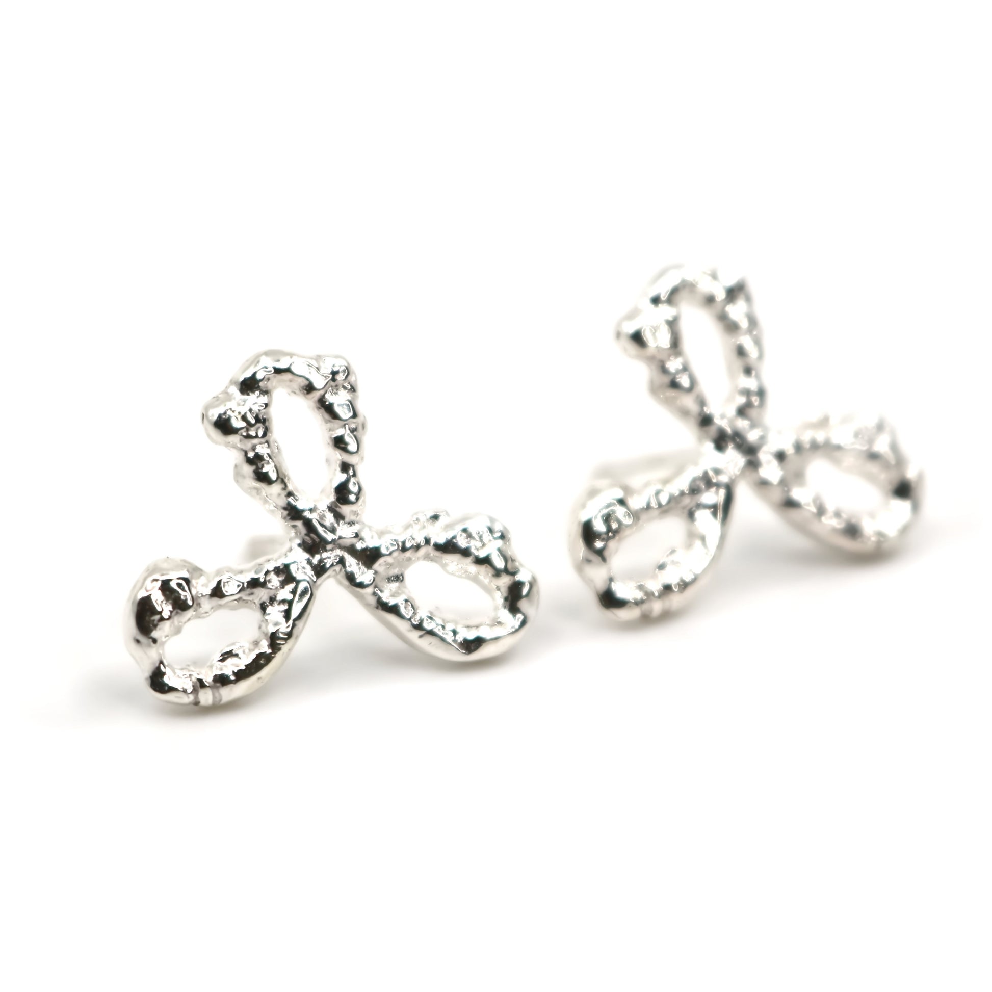Pair of silver 3 petal flower earrings on a white background