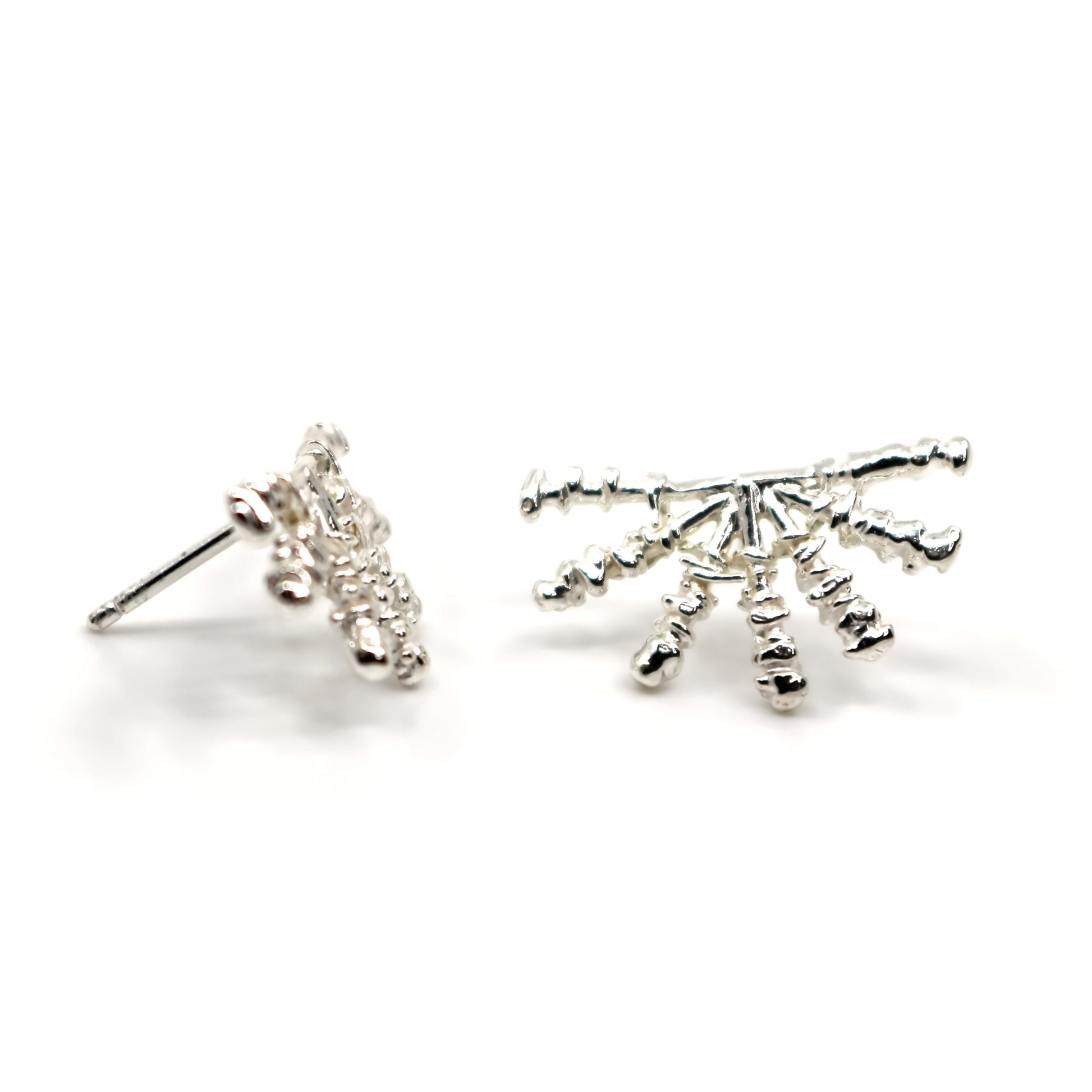 Alternate view of silver sunray shaped earrings on a white background