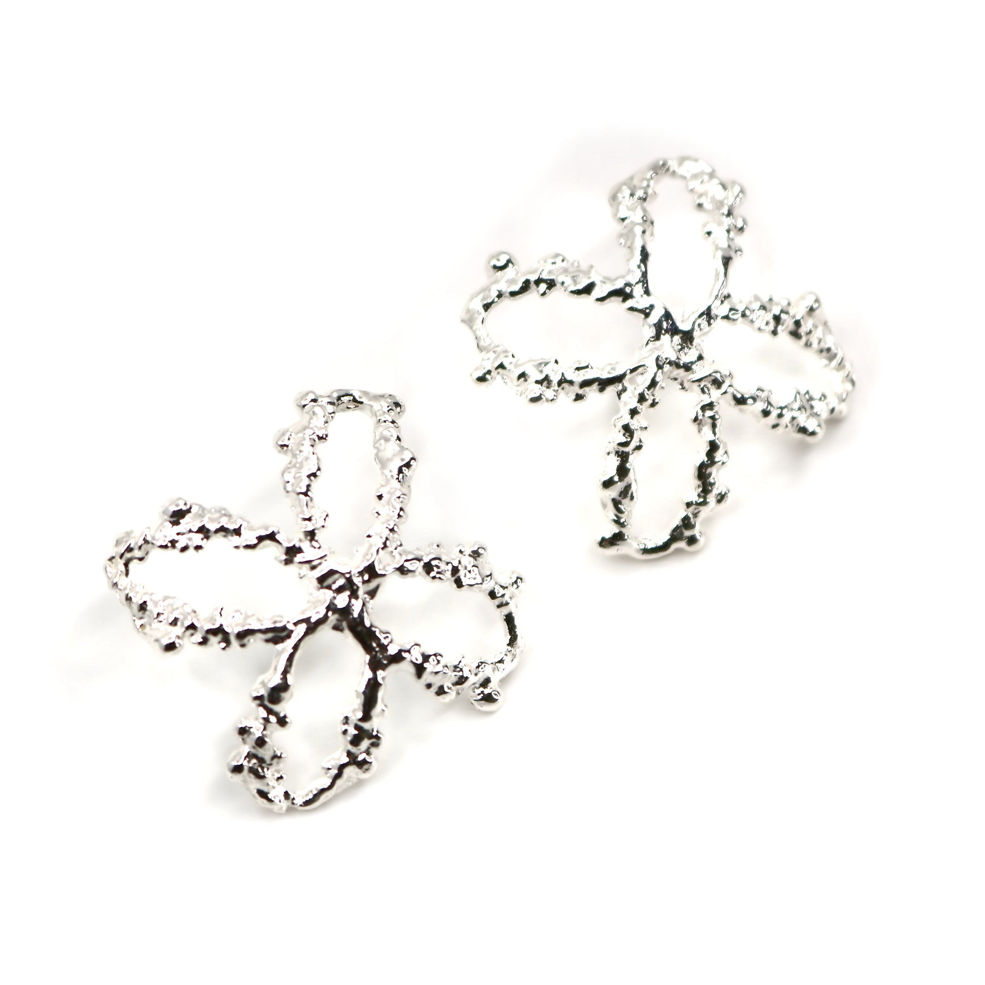 Pair of cross shaped silver earrings on a white background