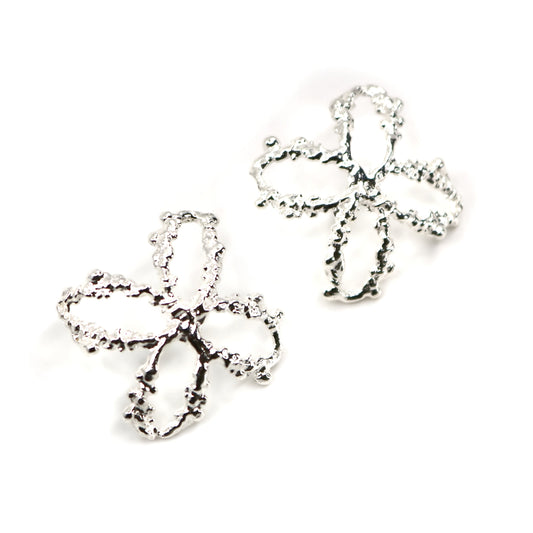 Pair of cross shaped silver earrings on a white background